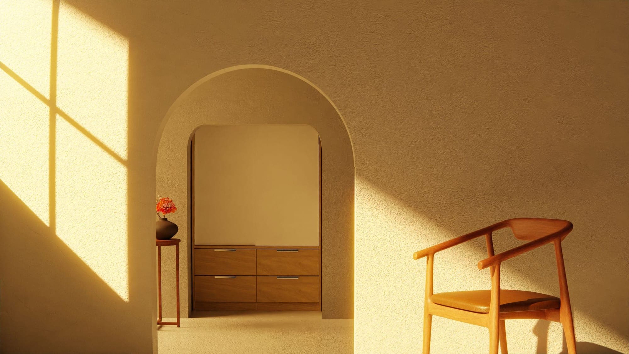 A room with an arched doorway and a chair in the evening sun